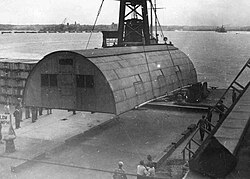 A Quonset hut being put in place at the 598th Engineer Base Depot in Japan, post–World War II